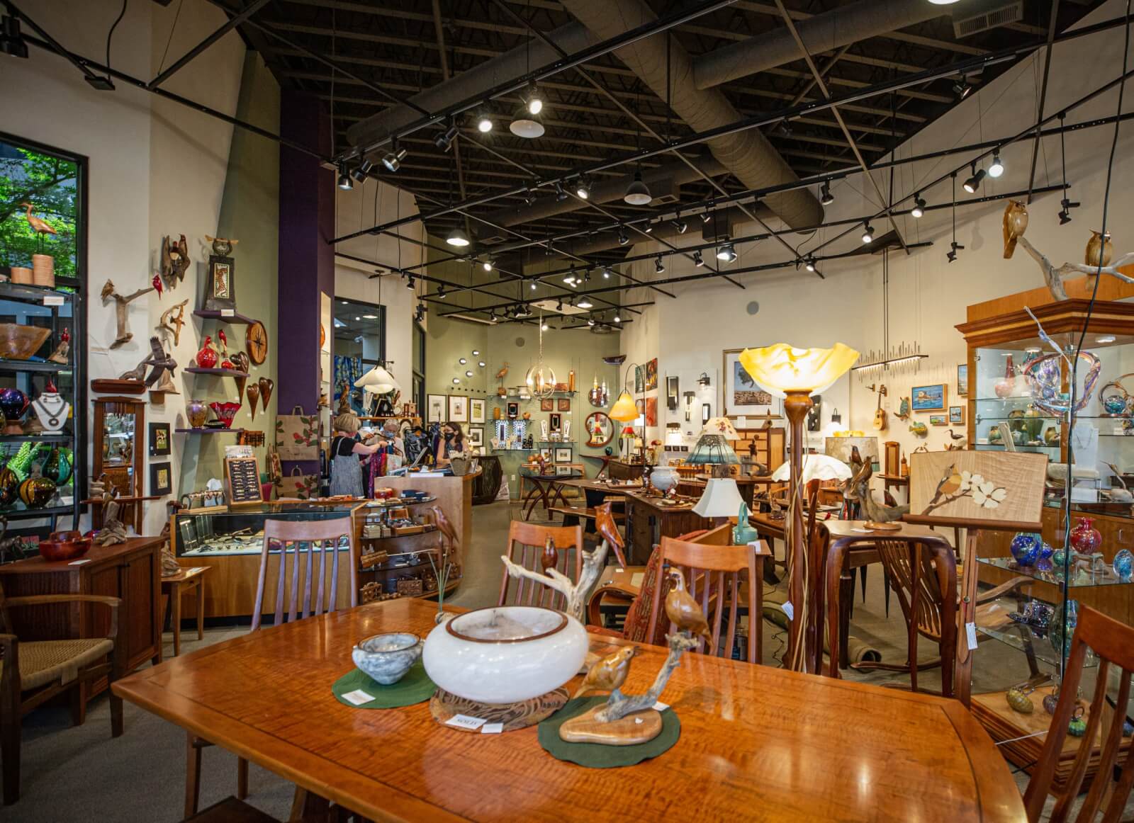 Dovetail Collection A spacious antique store filled with wooden furniture, decorative lamps, and various art pieces in Healdsburg, California.