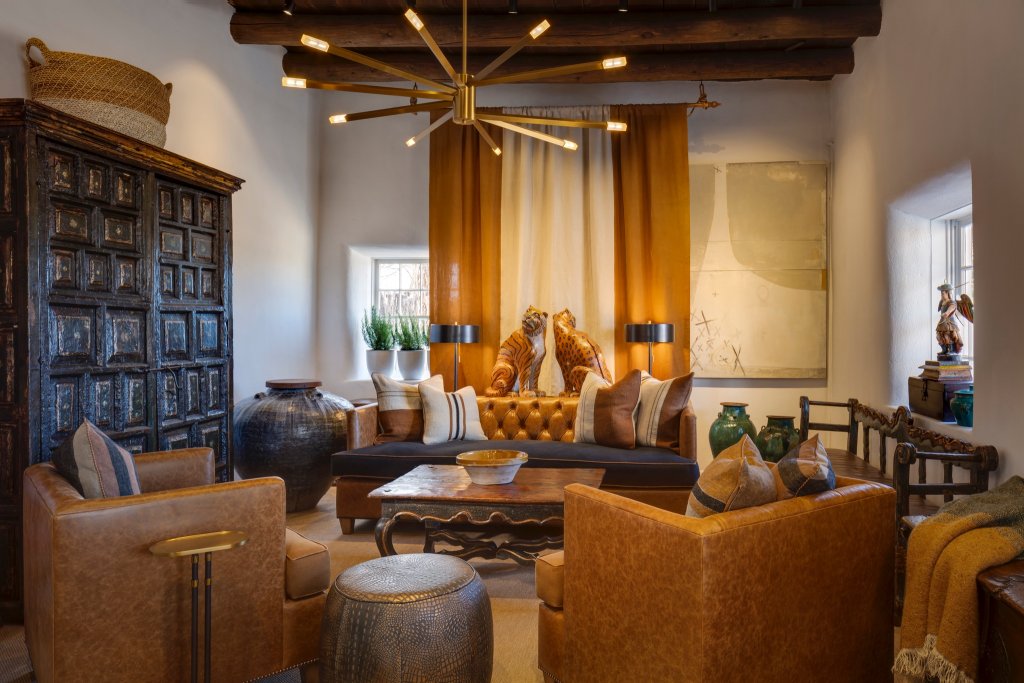 A rustic living room with leather furniture, a wooden coffee table, and a chandelier in Healdsburg, California.