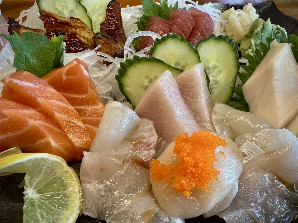 Assorted sashimi platter featuring salmon, tuna, sea bream, and cucumber garnishes in Healdsburg, California.