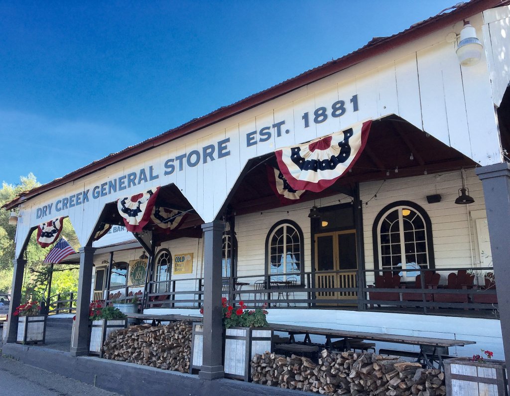 A quaint, historic general store with a covered porch and patriotic decorations in Healdsburg, California.