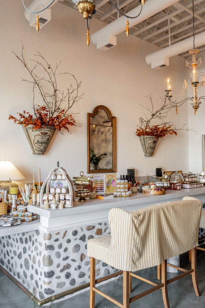 A cozy, rustic-chic kitchen with a stone-tiled bar, striped bench, and autumnal decor in Healdsburg, California.
