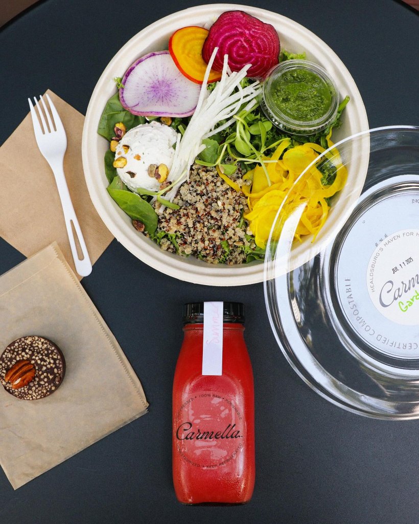 A colorful salad with beets, radishes, and greens, accompanied by a red juice and a chocolate cookie in Healdsburg, California.