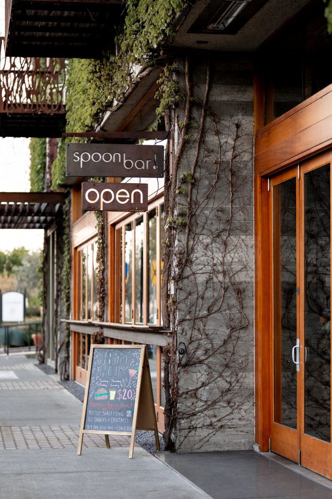 List Your Business A charming outdoor cafe with wooden doors, ivy-covered walls, and a chalkboard menu in Healdsburg, California.