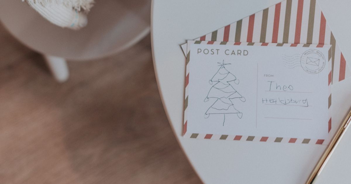 Postales al Polo Norte en Bon Ton Baby A child's hand-drawn Christmas card featuring a tree and a message from 'Theo' lies on a table in Healdsburg, California.