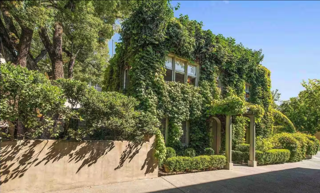 A lush, ivy-covered house nestled among mature trees and manicured hedges in Healdsburg, California.