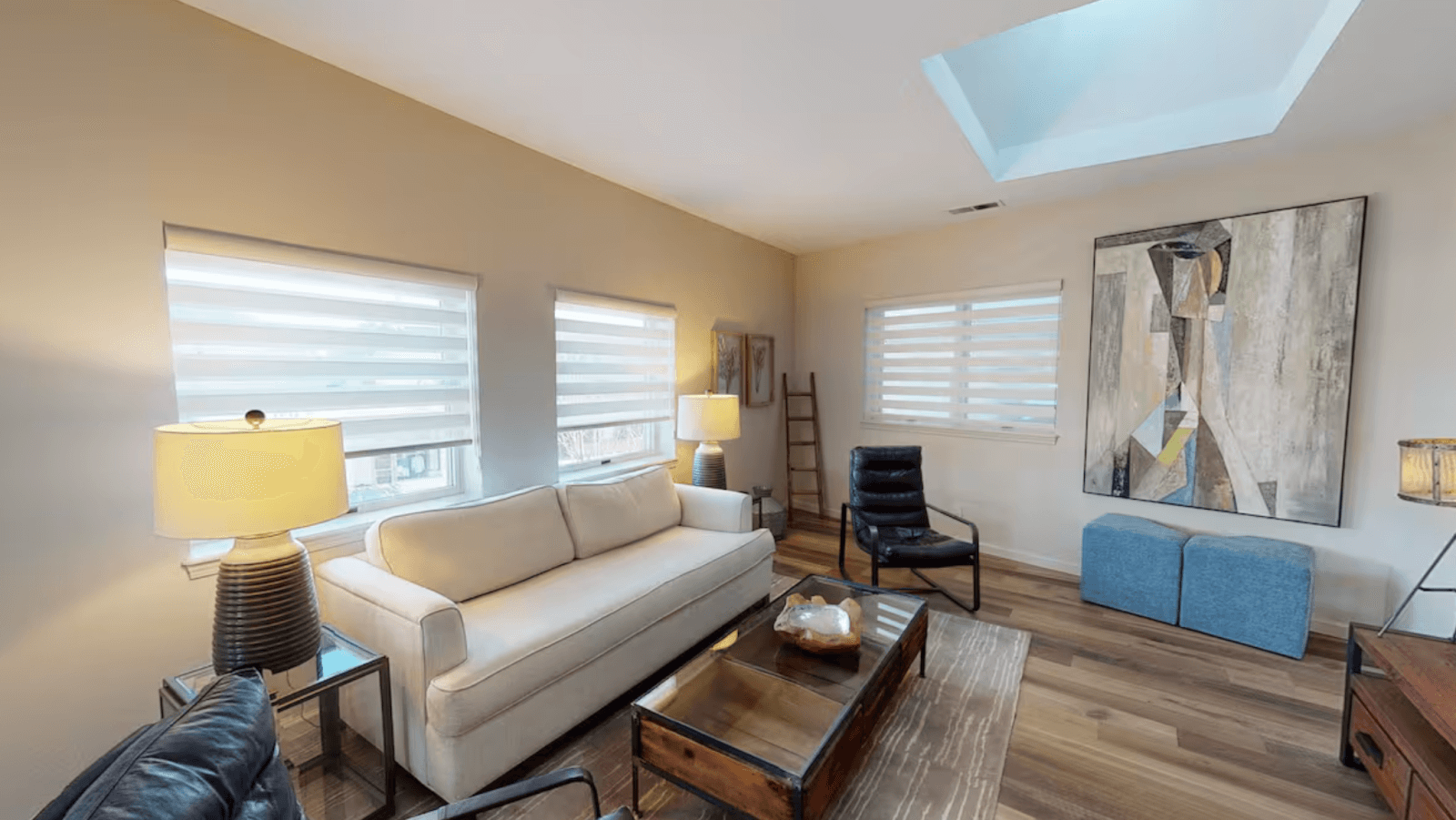 A modern living room with a white sofa, abstract art, and a skylight in Healdsburg, California.