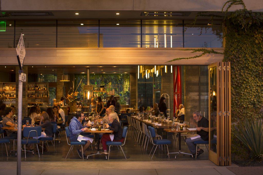 Patrons enjoy dinner at a bustling, modern restaurant with an open floor plan in Healdsburg, California.