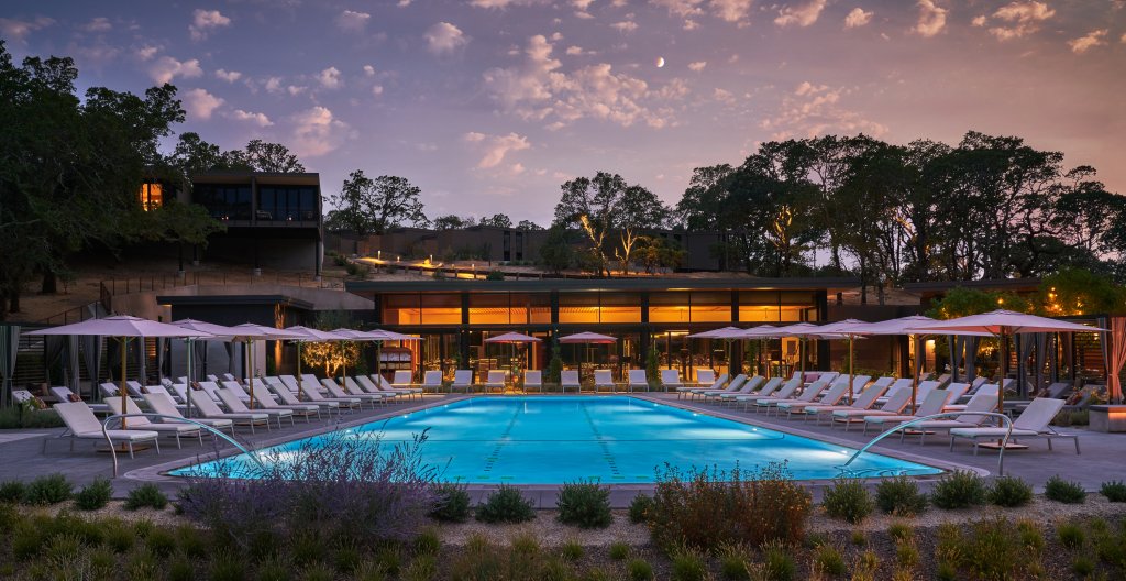 A serene swimming pool surrounded by lounge chairs at sunset in Healdsburg, California.